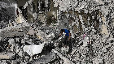 A Palestinian man inspects the damage to a building after Israeli forces raided the West Bank city of Jenin, Thursday, May 23, 2024. 