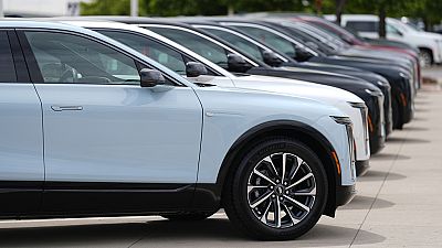 Unsold 2024 electric Lyriq utility vehicles sit in a row outside a Cadillac dealership Sunday, June 2, 2024, in Lone Tree, Colo. (AP Photo/David Zalubowski)