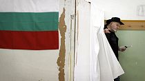 A Bulgarian walks out of a voting booth to cast his ballot for parliamentary elections in Sofia, Sunday, May 12, 2013 (AP Photo/Valentina Petrova)