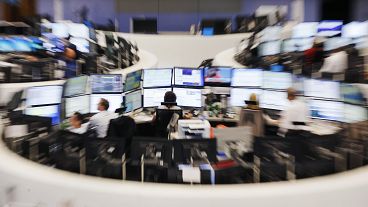 Traders sit in front of their screens at the stock market in Frankfurt, Germany (file photo)