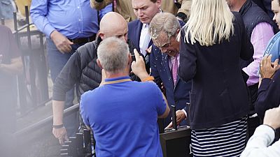 Reform UK leader, Nigel Farage, doused with a drink