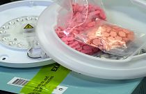Ecstasy pills that were hidden in a ceiling light fixture are displayed at the U.S. Customs and Border Protection overseas mail inspection facility.