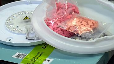 Ecstasy pills that were hidden in a ceiling light fixture are displayed at the U.S. Customs and Border Protection overseas mail inspection facility.