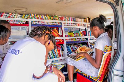 Pupils devour several pages during two hours of reading in the bus set up for the purpose in the courtyard of this public school.