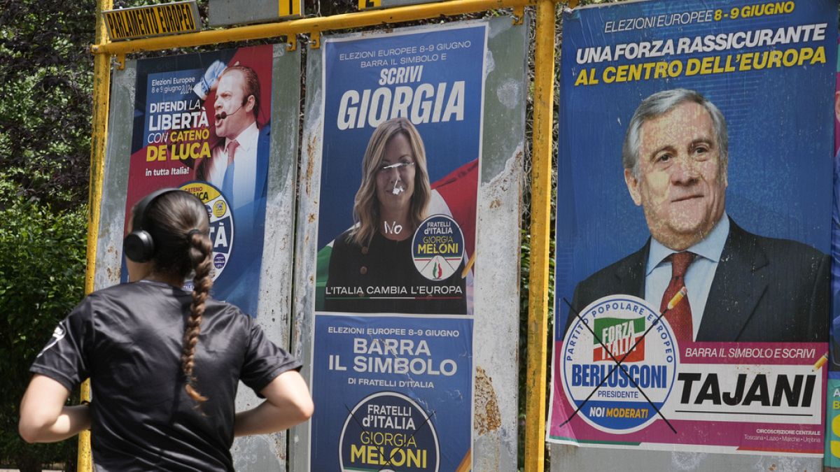 A woman jogs past European Parliament electoral posters in Rome, Thursday, May 30, 2024.