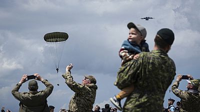 People attend a multinational parachute drop as some 400 British, Belgian, Canadian and US paratroopers jump to commemorate the contribution of airborne forces on D-Day.