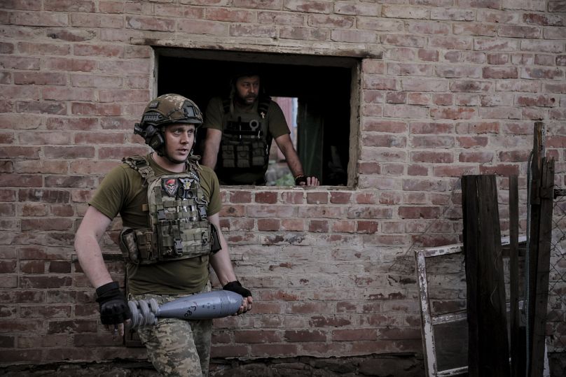 Ukrainian soldiers prepare to fire 120mm mortar towards Russian position on the front line at undisclosed location in Donetsk region, June 2024