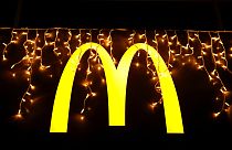 Christmas lights are hung above the logo outside a McDonald's restaurant in Lisbon, Tuesday, Dec. 14, 2021. (AP Photo/Armando Franca)