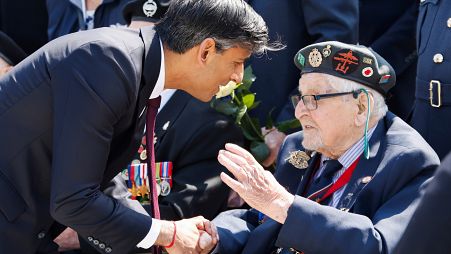 Britain's Prime Minister Rishi Sunak meets a British D-Day veteran during a commemorative ceremony marking the 80th anniversary of the D-Day landings.