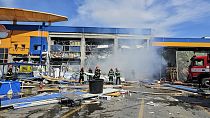Romanian Emergency Services (ISU Botosani), firefighters work at the scene of an explosion at a chain DIY store in Botosani, Romania, Friday, June 7, 2024