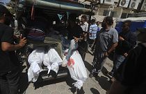Palestinianos mortos nos bombardeamentos israelitas na Faixa de Gaza são levados para o Hospital al-Aqsa em Deir al-Balah, no centro da Faixa de Gaza, sábado, 8 de junho de 2024.