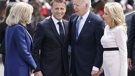 French President Emmanuel Macron, second left, his wife Brigitte Macron, left, welcome President Joe Biden and First Lady Jill Biden before a ceremony at the Arc de Triomphe, 