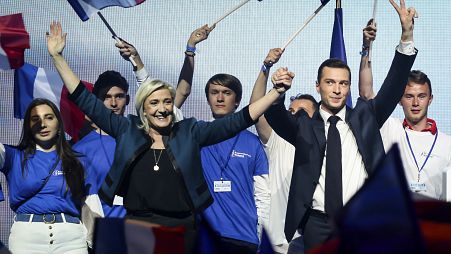 Leader of the French National Rally Marine Le Pen and lead candidate of the party for the upcoming EU election Jordan Bardella attend a political meeting June 2, 2024 in Paris