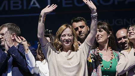  Giorgia Meloni and Brothers of Italy fellow party members wave during an electoral rally ahead of the EU parliamentary elections, June 1, 2024. 