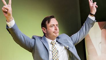 FILE - Leader of the NVA (New Flemish Alliance) Bart De Wever makes a victory sign after winning the Belgian federal and regional elections, in Brussels, May 25, 2014. 