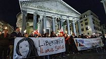 Demonstrators hold up a banner at left with writing reading in Italian "Lets free Ilaria Salis", in front of the Pantheon monument, in Rome, Wednesday, Feb. 14, 2024.