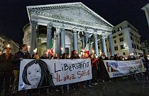 Demonstrators hold up a banner at left with writing reading in Italian "Lets free Ilaria Salis", in front of the Pantheon monument, in Rome, Wednesday, Feb. 14, 2024