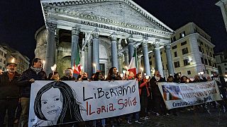 Demonstrators hold up a banner at left with writing reading in Italian "Lets free Ilaria Salis", in front of the Pantheon monument, in Rome, Wednesday, Feb. 14, 2024
