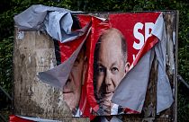 A damaged election poster shows German Chancellor Olaf Scholz in Frankfurt, Germany, Monday, June 10, 2024.
