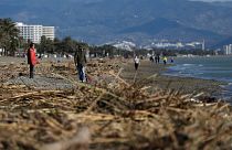 People walk along the beach after storm Gloria battered Spain's eastern coast in Torremolinos, Spain in 2020. 