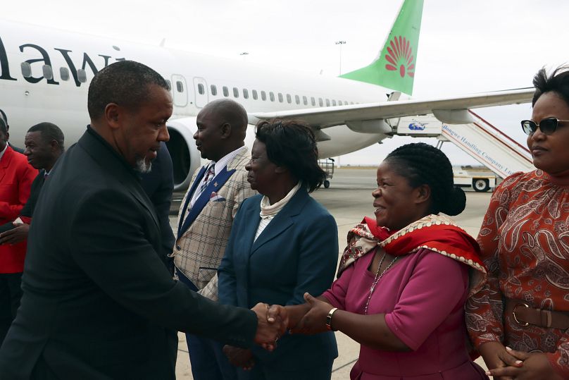 Malawi Vice President Saulos Chilima greets government officials upon his return from South Korea in Lillongwe, 9 June 2024.