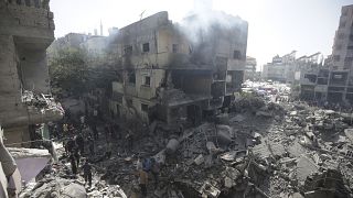 Palestinians look at the aftermath of the Israeli bombing in Nuseirat refugee camp, June 8, 2024