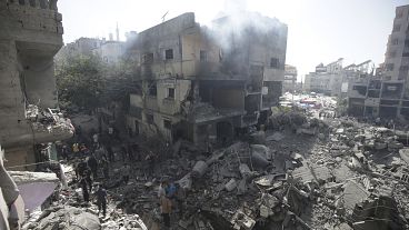 Palestinians look at the aftermath of the Israeli bombing in Nuseirat refugee camp, June 8, 2024