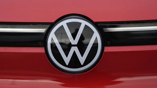 The company logo shines off the grille of an unsold 2023 electric ID.4 sports-utility vehicle at a Volkswagen dealership Sunday, March 17, 2024, in Denver. 
