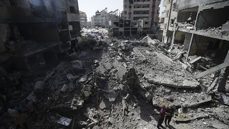 Palestinians look at the aftermath of the Israeli bombing in Nuseirat refugee camp, Gaza Strip, on June 8, 2024. 