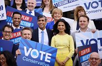 UK's Conservative Prime Minister and his wife Akshata Murty pose with supporters upon arrival to launch his party's manifesto