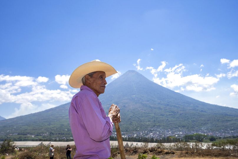 A member of an association of small coffee growers learns to collect ground samples during a training session at the Santa Barbara farm in San Juan Alotenango, March 2022