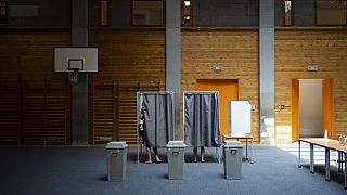 People vote at a polling station during the European Parliamentary elections, in Budapest, Hungary, Sunday, June 9, 2024. (AP Photo/Denes Erdos)