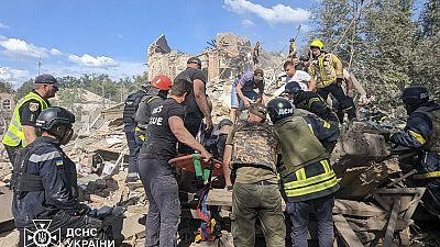 Emergency workers clear the rubble as they search for victims after a Russian missile hit the area, in Kryvyi Rih, Ukraine, Wednesday, June 12, 2024.