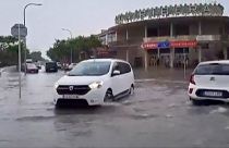 Cars driving through flooded traffic junction 