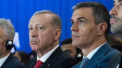 Spanish Prime Minister Pedro Sanchez sits next to Turkish President Recep Tayyip Erdogan, left, during a meeting in Madrid.