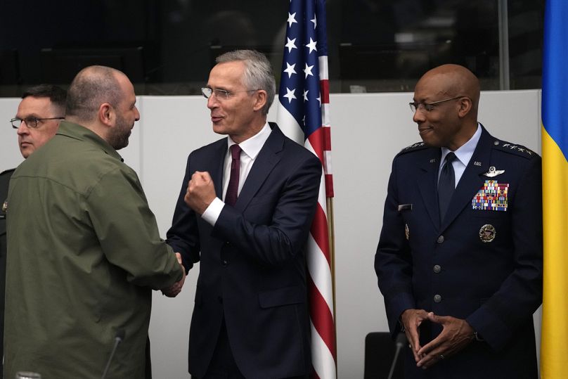 NATO Secretary General Jens Stoltenberg, center, and the Chairman of the Joint Chiefs of Staff Charles Brown, right, speak with Ukraine's Defense Minister Rustem Umerov