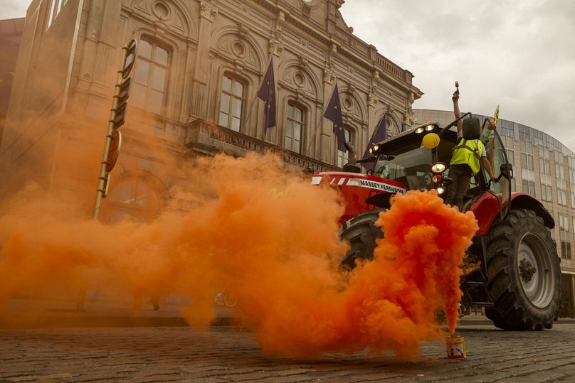 Farmers march with tractors during a protest outside the European Parliament in Brussels, June 2024