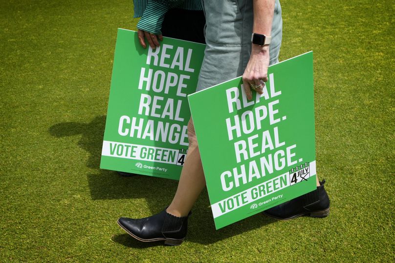Green Party supporters carry placards at their General Election Manifesto launch.