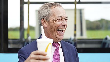 Leader of Reform UK Nigel Farage holds a banana milkshake in Jaywick, Essex, 4 June 2024