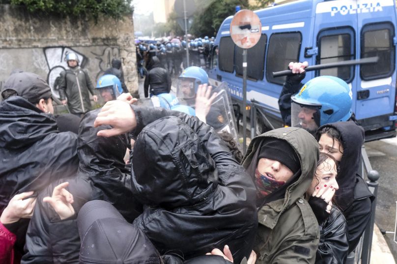 Protesters clash with riot police during the 'free Hungary, free Palestine' demonstration in support of Italian activist Ilaria Salis near the Hungarian Embassy in Rome, Italy