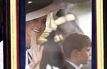 Kate, Princess of Wales waves to the crowd, with her youngest son Prince Louis of Wales alongside her in London, Saturday, June 15, 2024. 