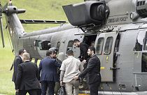 Ukraine's President Volodymyr Zelenskyy, centre, steps out of an Super Puma Swiss Airforce helicopter after his landing in Obbuergen near the Burgenstock Resort