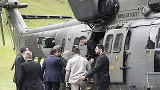 Ukraine's President Volodymyr Zelenskyy, centre, steps out of an Super Puma Swiss Airforce helicopter after his landing in Obbuergen near the Burgenstock Resort
