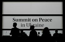 People walk in the media centre before the Ukraine peace summit in Switzerland, June 15, 2024
