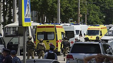 Russian policemen, Rosguardia servicemen and medical cars gather not far from a pretrial detention center in Rostov-on-Don, Russia, Sunday, June 16, 2024. 