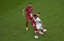 England's Jude Bellingham, right, is challenged by Serbia's Sasa Lukic during a Group C match between Serbia and England in Gelsenkirchen, June 16, 2024