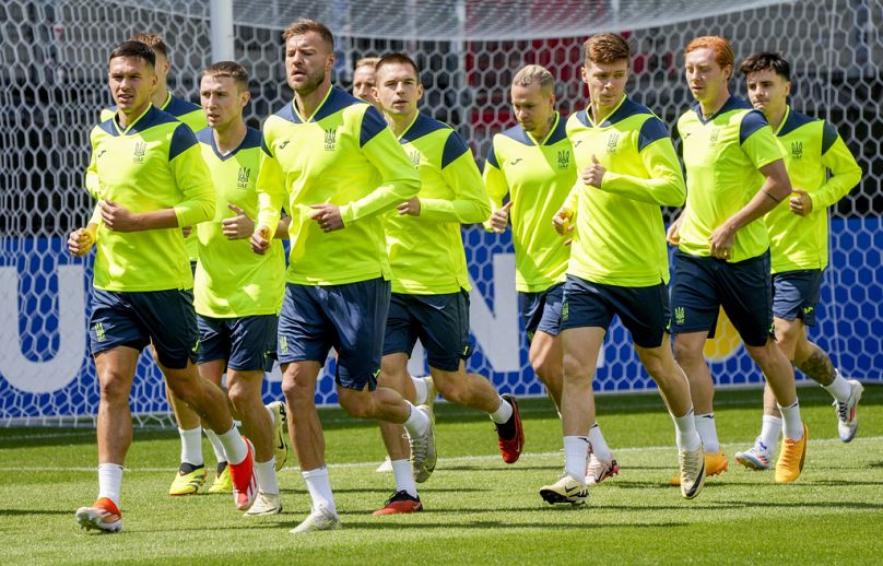 Players of Ukraine's national soccer team warm up during a public training session in Wiesbaden, Germany, Thursday, June 13, 2024, ahead of their group E match against Romania