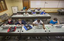 Children work on laptops during class.