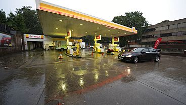 A car drives through the forecourt of a petrol station in Manchester which has run out of fuel after an outbreak of panic buying in the UK, Monday, Sept. 27, 2021.