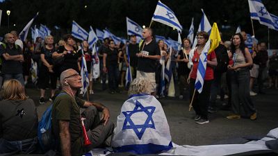 People take part in a protest against Israeli Prime Minister Benjamin Netanyahu's government, demanding new elections and the release of the hostages
